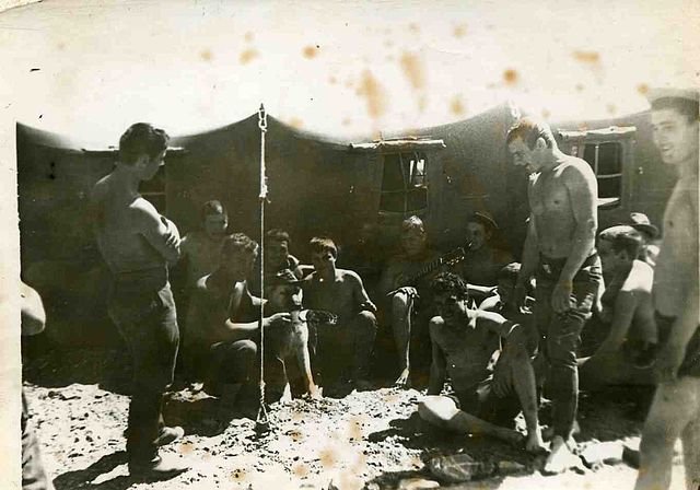 Soldiers next to a tent 