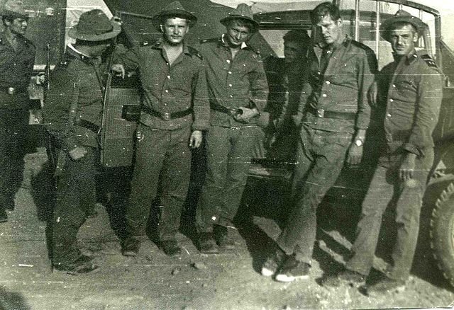 Soldiers with their trucks 