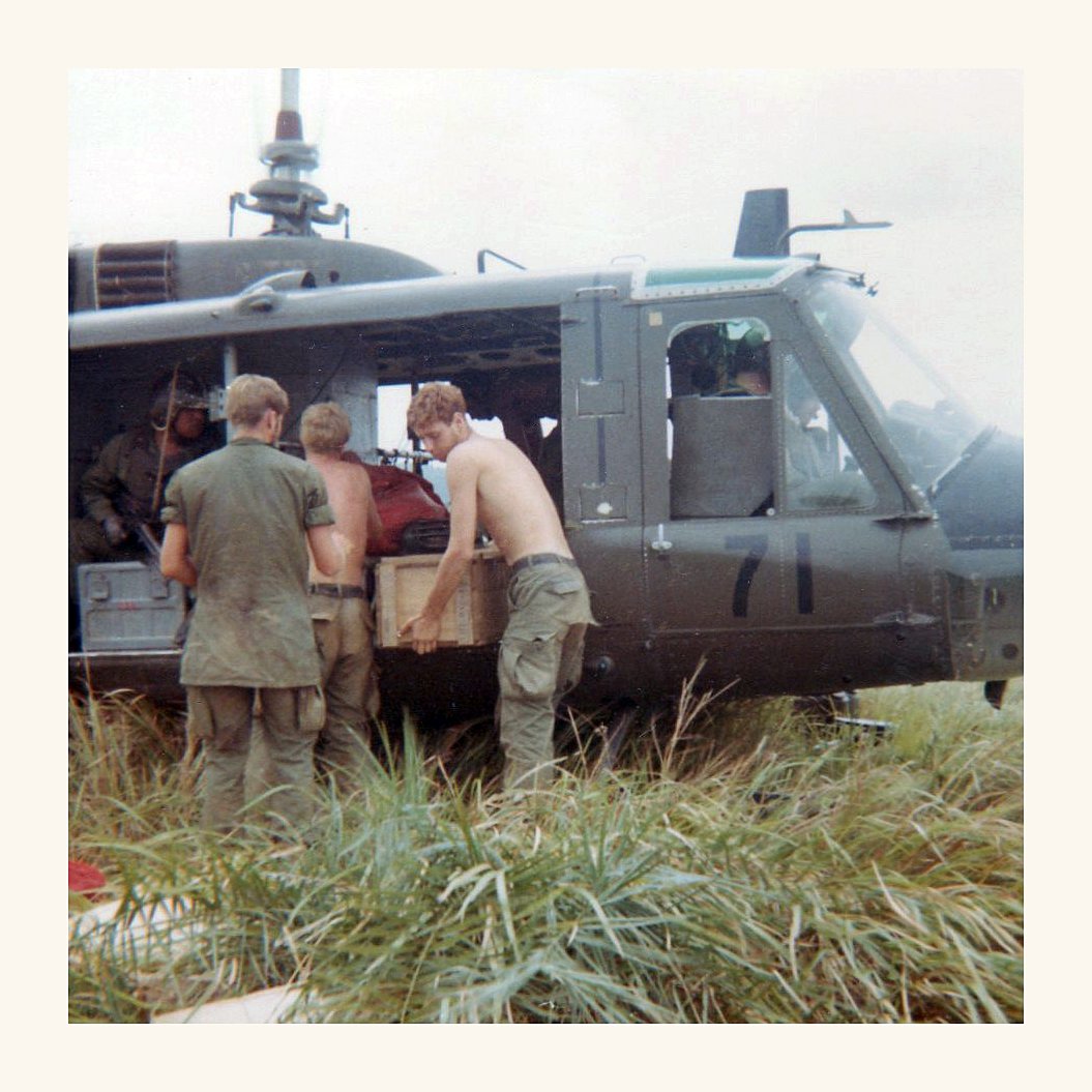 American soldiers in Vietnam unloading supplies from a helicopter 