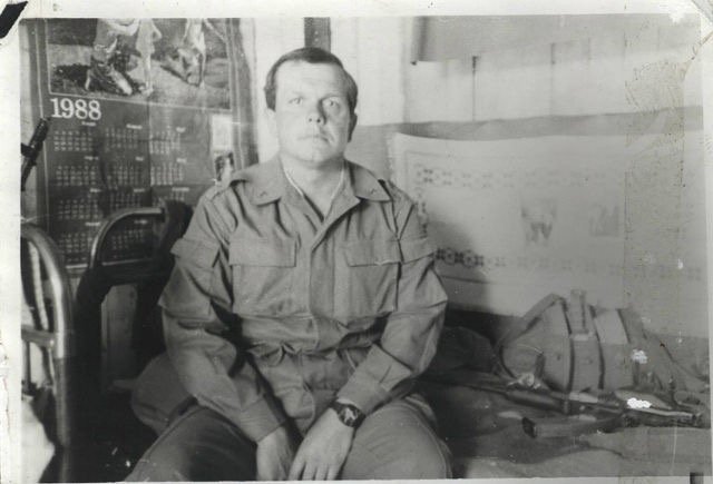 Soviet officer in a room with chest rig