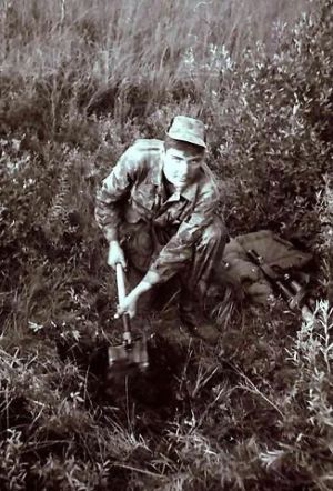 Soviet paratrooper digging a trench 